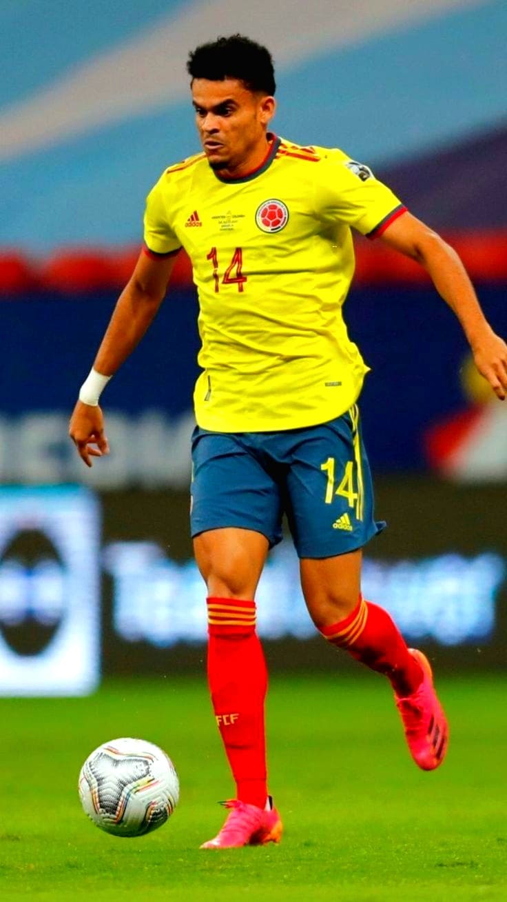 A soccer player in a yellow Colombia jersey with number 14 is running on the field, controlling the ball mid-game—a moment you won’t want to miss when you purchase IPTV and catch all the live action.