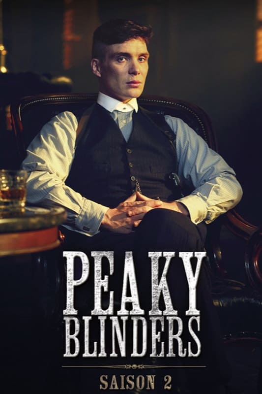 A man in a suit sits in a leather chair with his hands folded. The text “Peaky Blinders Saison 2” appears at the bottom. The setting is dimly lit and has a vintage feel, capturing the intrigue of the era—perfect for viewers looking to purchase IPTV and experience classic shows in style.