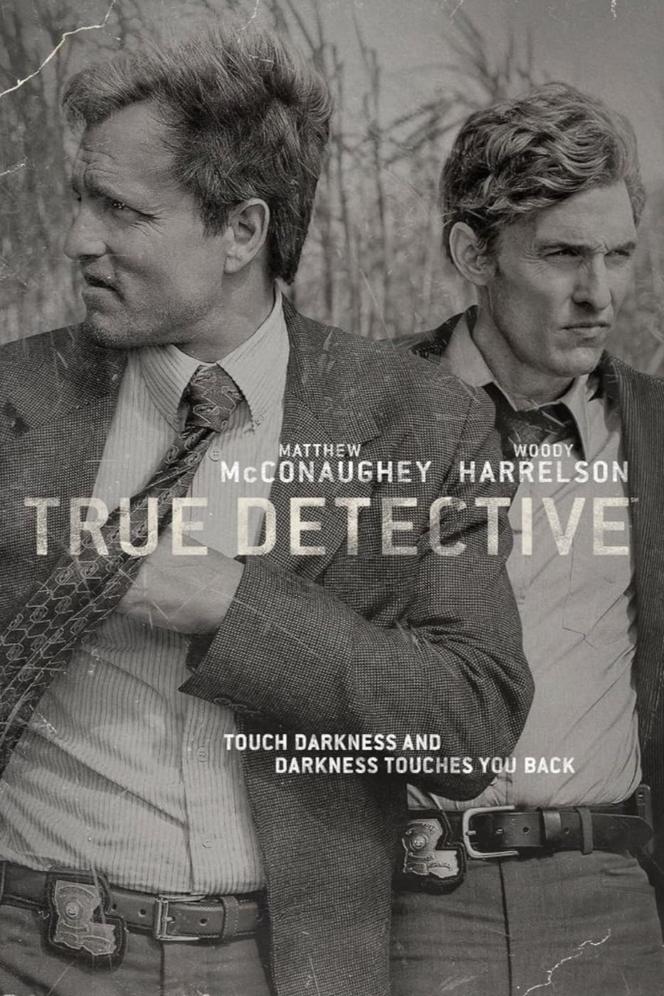 Two men in suits stand side by side, gazing in different directions. The text reads: Matthew McConaughey, Woody Harrelson. TRUE DETECTIVE. Touch darkness and darkness touches you back. For those who wish to immerse themselves further, Purchase IPTV to experience every gripping episode without interruption.